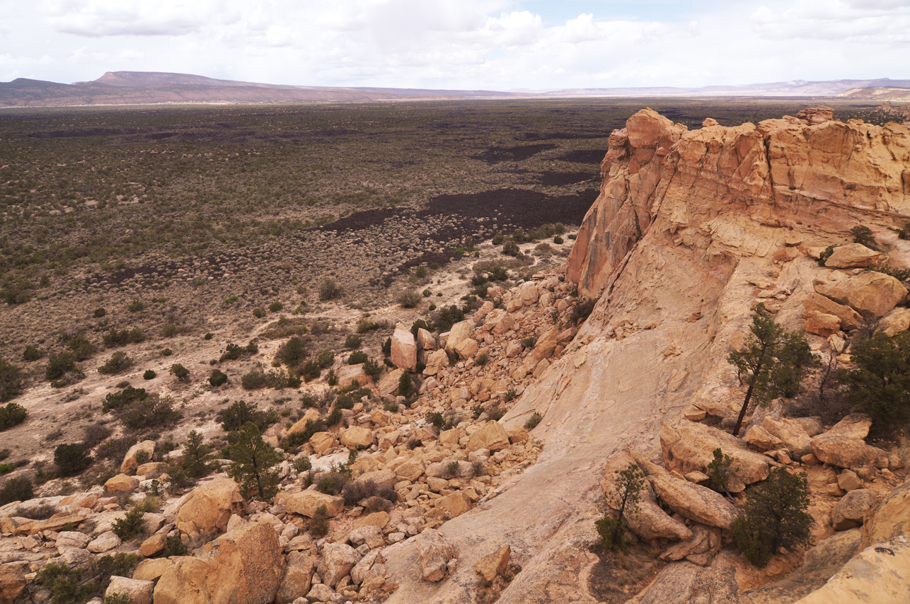 Sandstone bluffs overlooking lava flows fill valley for over 40 miles